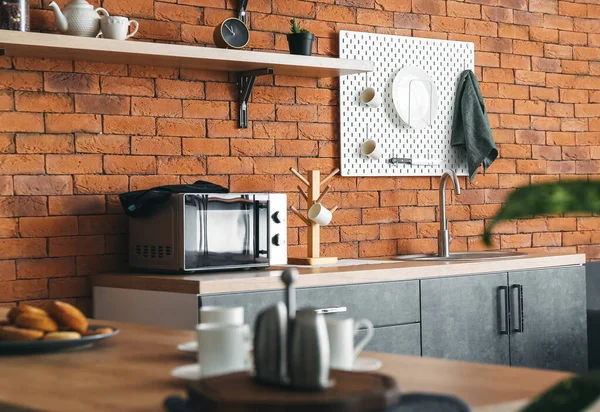 Interior Modern Kitchen Counters Hanging Pegboard Brick Wall — Stock Photo, Image