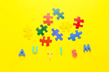 Renkli yapboz parçalarına sahip kelime AUTISM