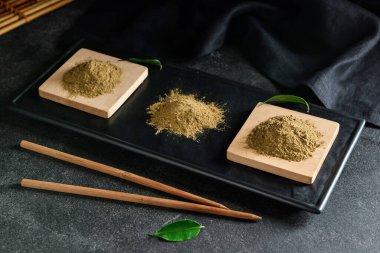 Siyah arkaplanda hojicha pudrası olan tahta