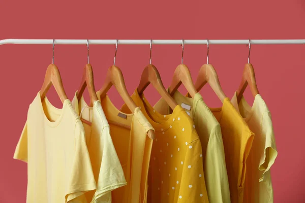 Regal Mit Sauberer Gelber Kleidung Auf Rosa Hintergrund Nahaufnahme — Stockfoto