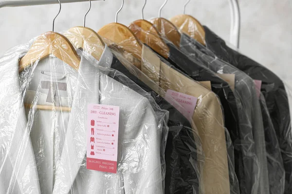 Rack Tiszta Kabát Műanyag Zacskókban Grunge Háttér Közelkép — Stock Fotó