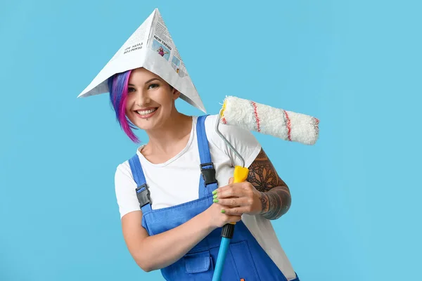 Female Painter Paper Hat Paint Roller Blue Background — Stock Photo, Image