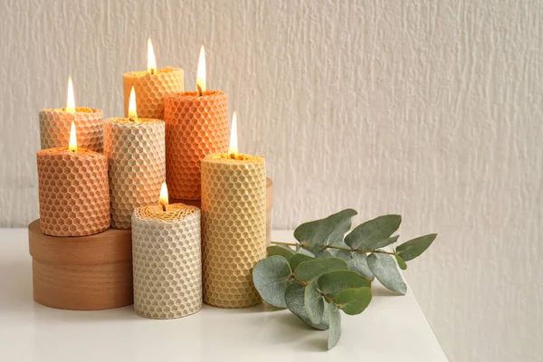 Burning Candles Eucalyptus Branch Table White Wall — Stock Photo, Image