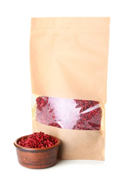 Bag and bowl with dried barberries on white background