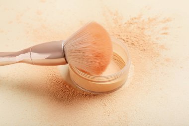 Açık arkaplanda makyaj fırçası ve gevşek toz