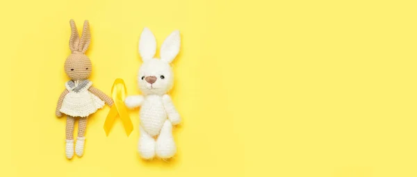 Bunny Toys Golden Awareness Ribbon Yellow Background Space Text International — Stock Photo, Image