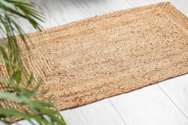 Odanın ahşap zemininde şık bir hasır halı