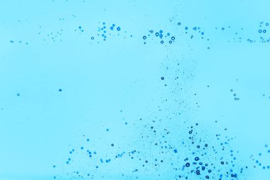 Mavi zemin üzerinde hava kabarcıkları olan temiz su