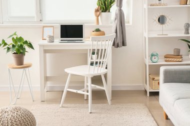 Modern işyeri, dizüstü bilgisayar ve raf üniteli aydınlatma odasının içi