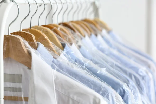 Rack Clean Shirts Plastic Bags Light Wall — Stock Photo, Image