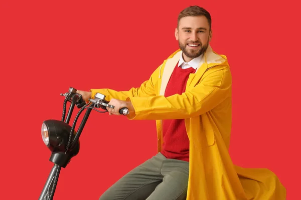 Young Man Raincoat Riding Bike Color Background — Stock Photo, Image