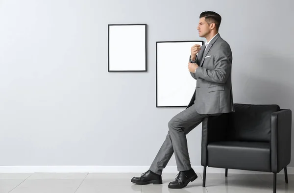 Fashionable Handsome Man Stylish Suit Adjusting Sleeve Grey Wall — Stock Photo, Image