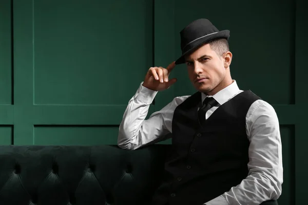 Fashionable Gentleman Stylish Hat Sitting Sofa Color Wall — Stock Photo, Image