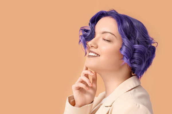 Beautiful young woman with violet hair on color background. Very Peri - color of year 2022