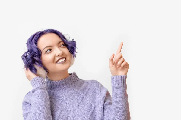 Beautiful Young Woman Violet Hair Fluffy Headphones Pointing Something White — Stock Photo, Image