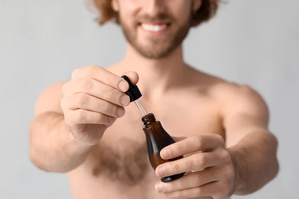 Young Man Serum Skin Care Grey Background Closeup — Stock Photo, Image