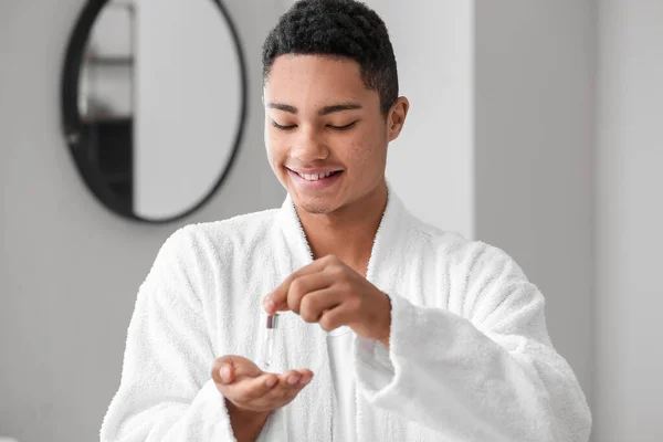 Young African American Guy Using Serum Skin Care Bathroom — Stock Photo, Image