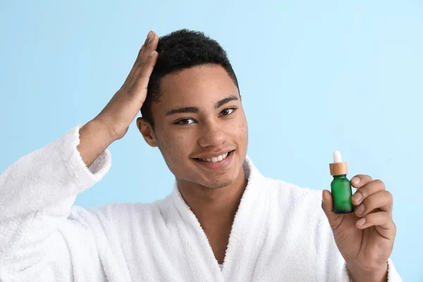 Young African American Guy Using Serum Hair Growth Color Background — Stock Photo, Image