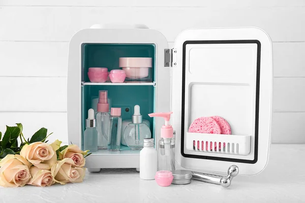 Small Refrigerator Cosmetic Products Flowers Light Table — Stock Photo, Image