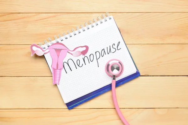 Notebook Word Menopause Paper Uterus Stethoscope Light Wooden Background — Stock Photo, Image