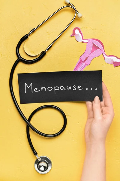 Woman Holding Paper Word Menopause Stethoscope Uterus Yellow Background — Stock Photo, Image