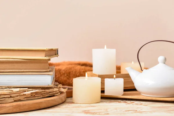 Stack Books Burning Candles Teapot Light Wooden Table — Stock Photo, Image