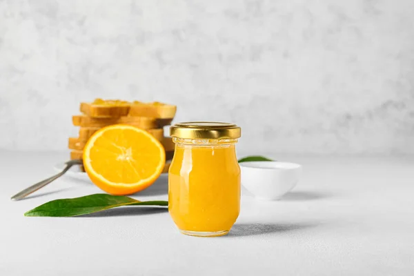 Glass Jar Tasty Orange Jam Light Background — Stock Photo, Image