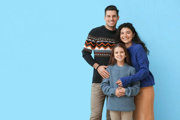 Little Girl Her Parents Warm Sweaters Hugging Blue Background — Stock Photo, Image