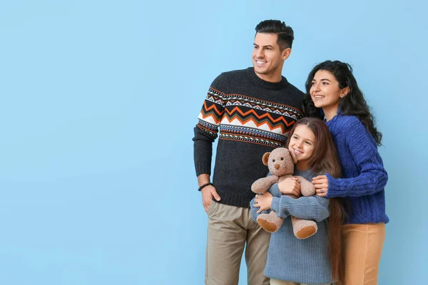 Little Girl Toy Her Parents Warm Sweaters Blue Background — Stock Photo, Image