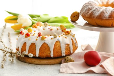 Tasty Easter cakes, pussy willow branches and eggs on table