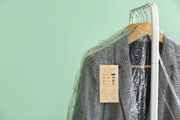 Rack Clean Checkered Jacket Plastic Bag Green Background Closeup — Stok Foto