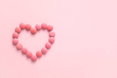 Pembe arka planda haplardan yapılmış kalp