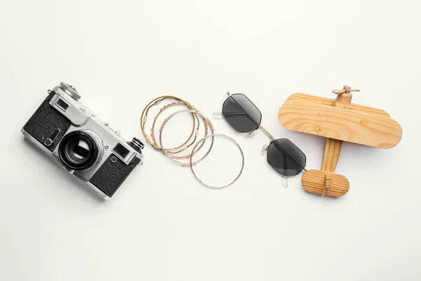 Stylish Sunglasses Bracelets Photo Camera Wooden Plane White Background — Stock Photo, Image