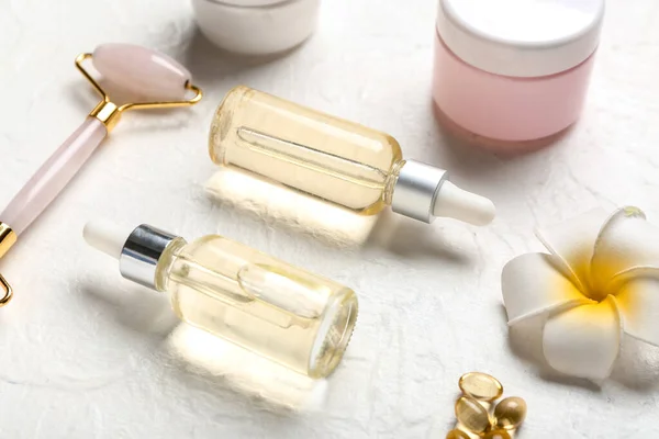 Bottles Essential Oil Facial Massage Tool Flower Light Background Closeup — Stock Photo, Image