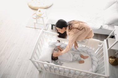 Genç anne ve tapılası bebeği evde uyuyor.