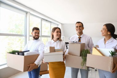 İş adamları taşınma gününde içinde eşyalar olan kutuları taşıyorlar.