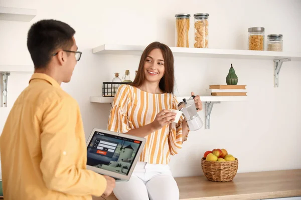 Young Woman Pouring Coffee Cup Her Husband Laptop Kitchen — Stock Photo, Image