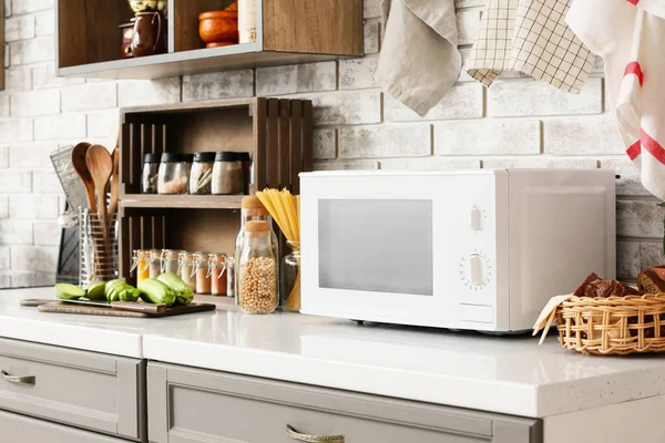 Counter Microwave Oven Food Light Brick Wall Kitchen — Stock Photo, Image
