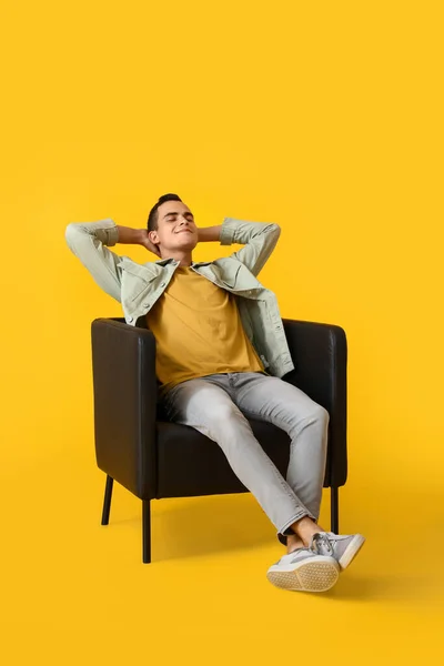 Young Man Resting Leather Armchair Yellow Background — Stock Photo, Image