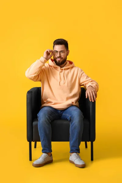 Handsome Bearded Man Eyeglasses Sitting Leather Armchair Yellow Background — Stock Photo, Image