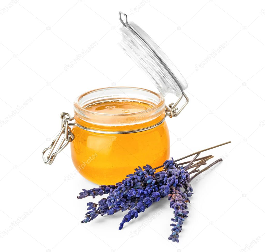 Opened jar with honey and lavender flowers on white background