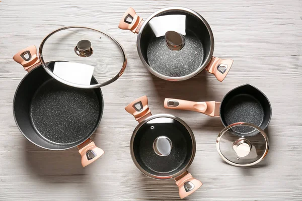 Set Different Cooking Pots Saucepan Grey Wooden Background — Stock Photo, Image