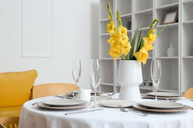 Gladiolus çiçekli vazo aydınlatma odasındaki servis masasında.