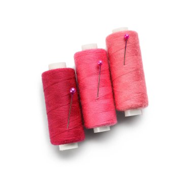 Beyaz arkaplanda pembe dikiş iplikleri