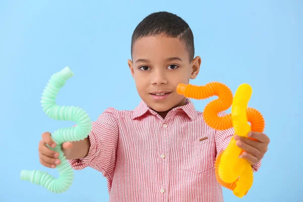 Little African American Boy Pop Tubes Blue Background — Stock Photo, Image