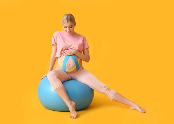 彩色背景应用动力学带的肥胖孕妇 — 图库照片