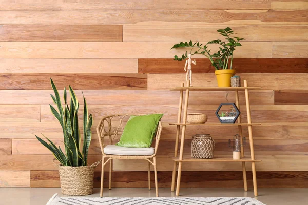 Interior of modern living room with houseplants and wooden wall