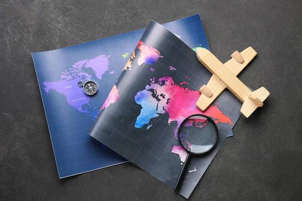 Wooden Plane Magnifying Glass Compass Maps Dark Background — Stock Photo, Image