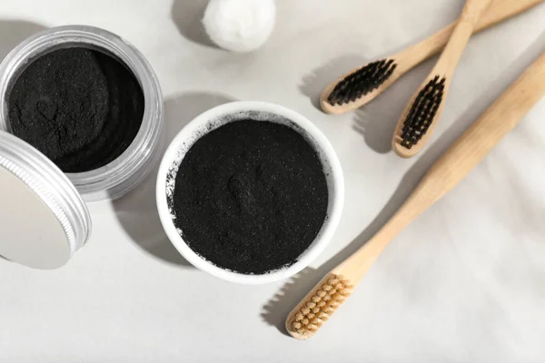 Composition Activated Charcoal Tooth Powder Toothbrushes Light Background Closeup — Stock Photo, Image