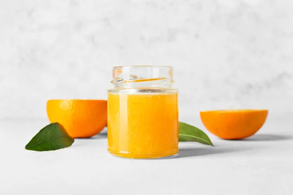 Glass Jar Tasty Orange Jam Light Background — Stock Photo, Image